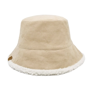 Detail view of beige corduroy bucket hat with plush fleece lining and leather label