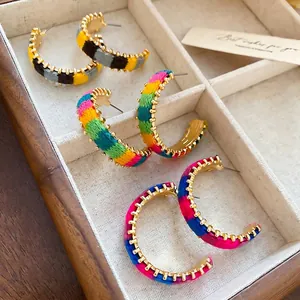 Handmade bohemian colorful woven C-shape hoop earrings with gold serrated metal trim