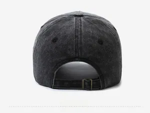 Detail of vintage washed black denim baseball cap with adjustable bronze metal buckle strap