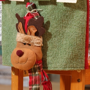 Christmas chair cover with 3D reindeer design on wooden chair for festive dining decor