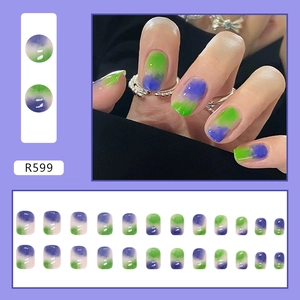 Detail of green and purple gradient press-on nails in oval shape with glossy finish