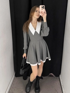 Close-up of contrast white pointed collar and puff sleeve detail on gray A-line dress