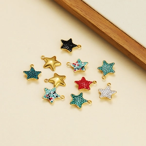 Macro shot of assorted gold star pendants with colorful rhinestones for DIY jewelry