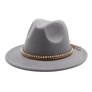 Detail of grey wool fedora hat with brown braided leather band and gold beaded chain