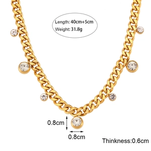 Gold Cuban link necklace with round zircon pendants on white background for women
