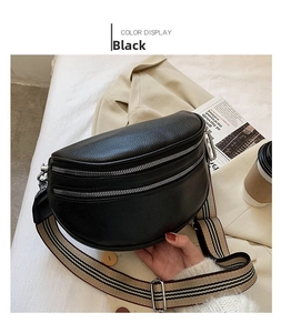 Detail of black lychee grain leather waist bag with striped strap and silver zipper
