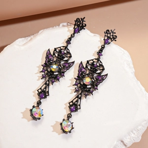 Gothic hollow metal earrings with purple enamel and iridescent gemstones on stone base