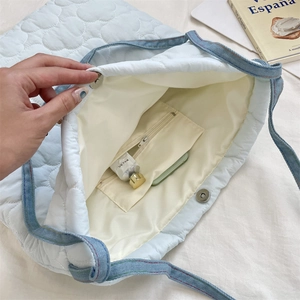 Détail intérieur du sac cabas matelassé bleu clair avec doublure et poche zippée