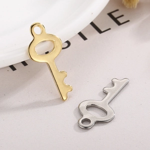 Sleek gold and silver hollow key charms for DIY jewelry making on white aesthetic decor
