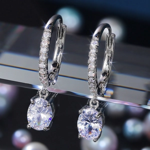 Elegant silver earrings with oval cubic zirconia drop and micro-pave setting
