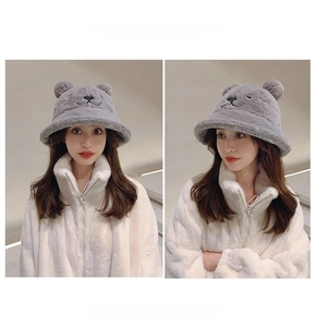 Detail of plush grey bucket hat with bear ears showing thick warm faux fur texture