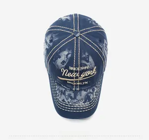 Detailed close-up of vintage navy denim baseball cap with yellow Brooklyn embroidery