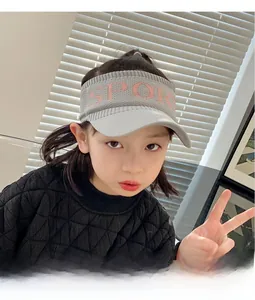 Close-up of children grey knit visor hat with pink Sport text on the front band