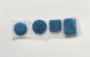 Detail view of blue pocket mirrors in protective bubble wrap packaging against a white background