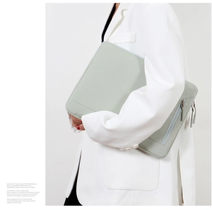 Minimalist sage green laptop sleeve with water-resistant fabric and side zipper pocket