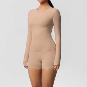 Close-up of nude long-sleeve yoga set featuring high-elasticity fabric and body-con fit