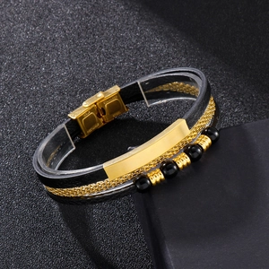 Detail of multi-layer men's bracelet with black leather, gold chain, and stainless steel clasp