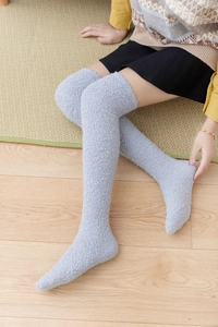 Detail of grey coral fleece over-knee socks showing soft texture and cozy winter warmth