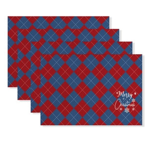 Detail of four Christmas placemats with red and blue plaid and Merry Christmas text