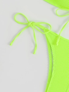 Detailed macro view of fluorescent green ribbed bikini bottom with side tie strings