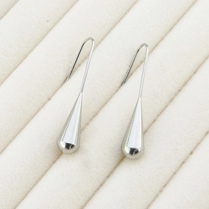 Detail showing matte and polished finishes on silver stainless steel teardrop earrings