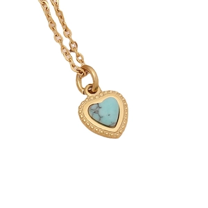 Golden heart pendant necklace with sky blue enamel cross and beaded edge on white background