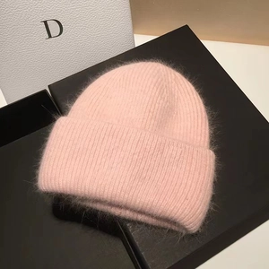 Close-up of soft pink rabbit fur knit beanie showing premium plush texture and material