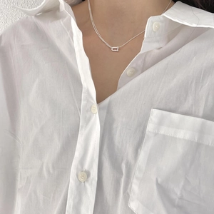 Minimalist 925 sterling silver U-buckle necklace on model with white shirt background