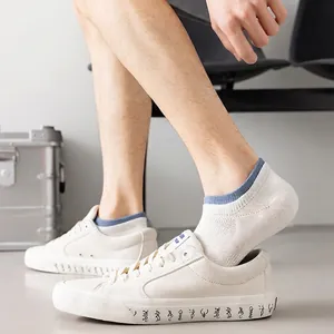 Mens breathable mesh invisible socks in beige and navy blue worn with canvas shoes