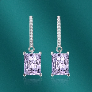 Detailed view of rectangular purple zircon earrings with pave-set shimmering stones