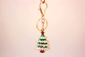 Detail of Christmas tree keychain with green enamel, rhinestones and golden lobster clasp