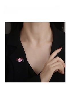 Pink axolotl enamel pin with 'I like you a lot' text shown on a black suit jacket