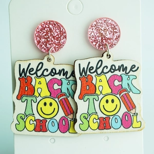Detail of wooden drop earrings with Welcome Back to School text and pencil graphics