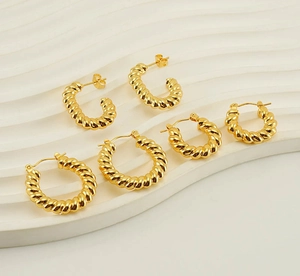 Detailed comparison of three sizes of gold twisted hoop earrings with a rope design