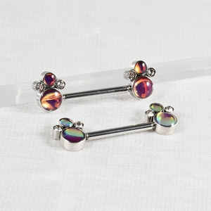 Detailed shot of silver barbell nipple rings with opal claw cluster and zircon accents