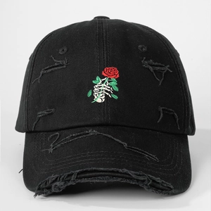 Detailed close-up of distressed cotton baseball cap with skull hand and rose embroidery