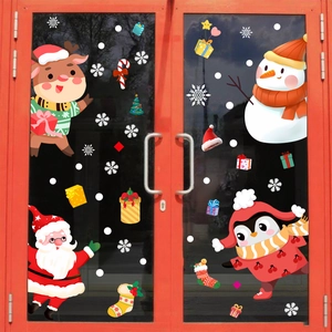 Detail view of Santa Claus and reindeer window stickers on a glass door for Christmas