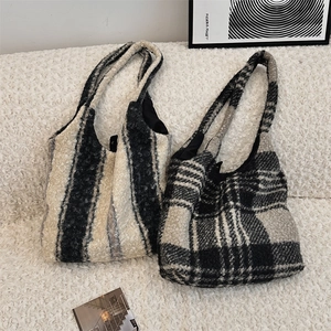 Detailed texture of plush oversized tote bags with black and white stripes and grid patterns