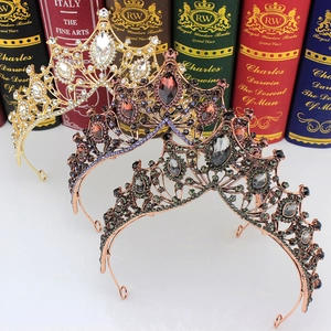 Detailed close-up of vintage baroque crowns in gold, bronze, and black with gemstones