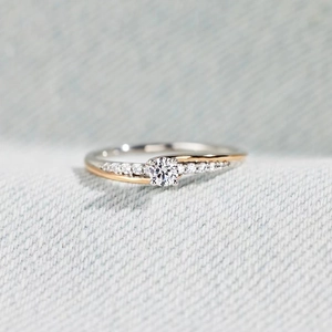 Elegant S925 sterling silver two-row diamond ring with gold accents and a round center stone