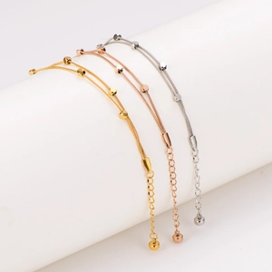 Three colors of double-layer snake bone chain bracelets with beads on a white stand