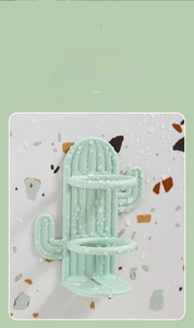 Detail of green cactus-shaped wall toothbrush holder with drainage slots and waterproof coating