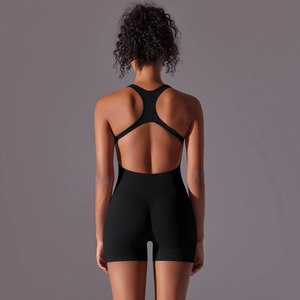 Detailed view of racerback open back design on black seamless athletic bodysuit
