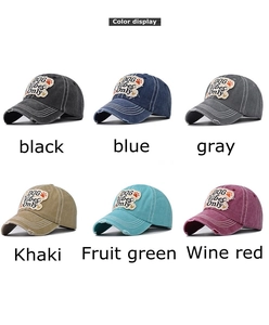 Detailed close-up of DOG Vibes Only embroidery on washed cotton baseball caps in six colors