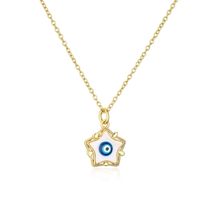 Macro shot of 18K gold plated star pendant with blue enamel evil eye detail on chain
