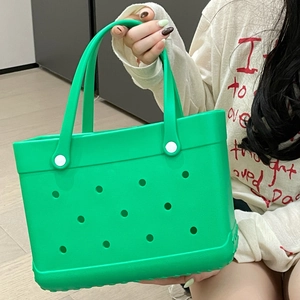 Close-up of green EVA beach tote bag featuring circular vent holes and white handle buttons