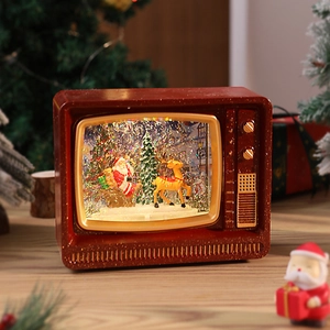 Detailed view of vintage TV Christmas snow globe box with Santa and glowing lights
