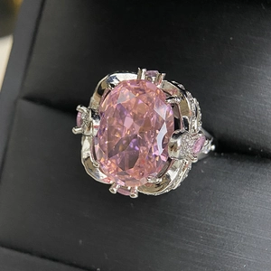 Detailed close-up of pink oval gemstone ring with 18k plating and micro-pave crystals