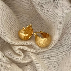 Elegant gold brushed texture sterling silver hoop earrings shown in a detailed close-up view