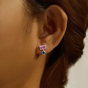 Detailed close-up of s925 silver stud with pink rectangle and blue round gemstones